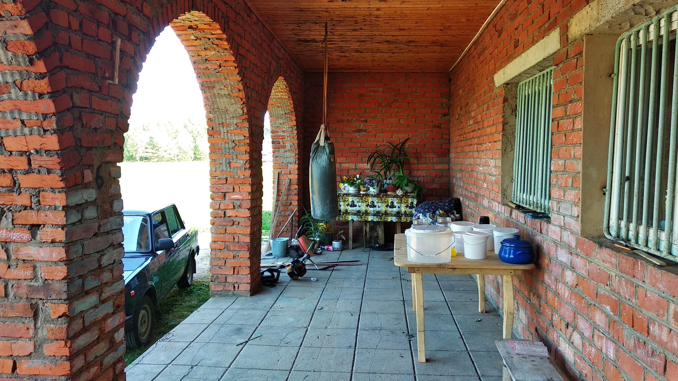 A house is for sale. A hangar, a plot of land for farming.