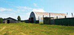 A house is for sale. A hangar, a plot of land for farming.