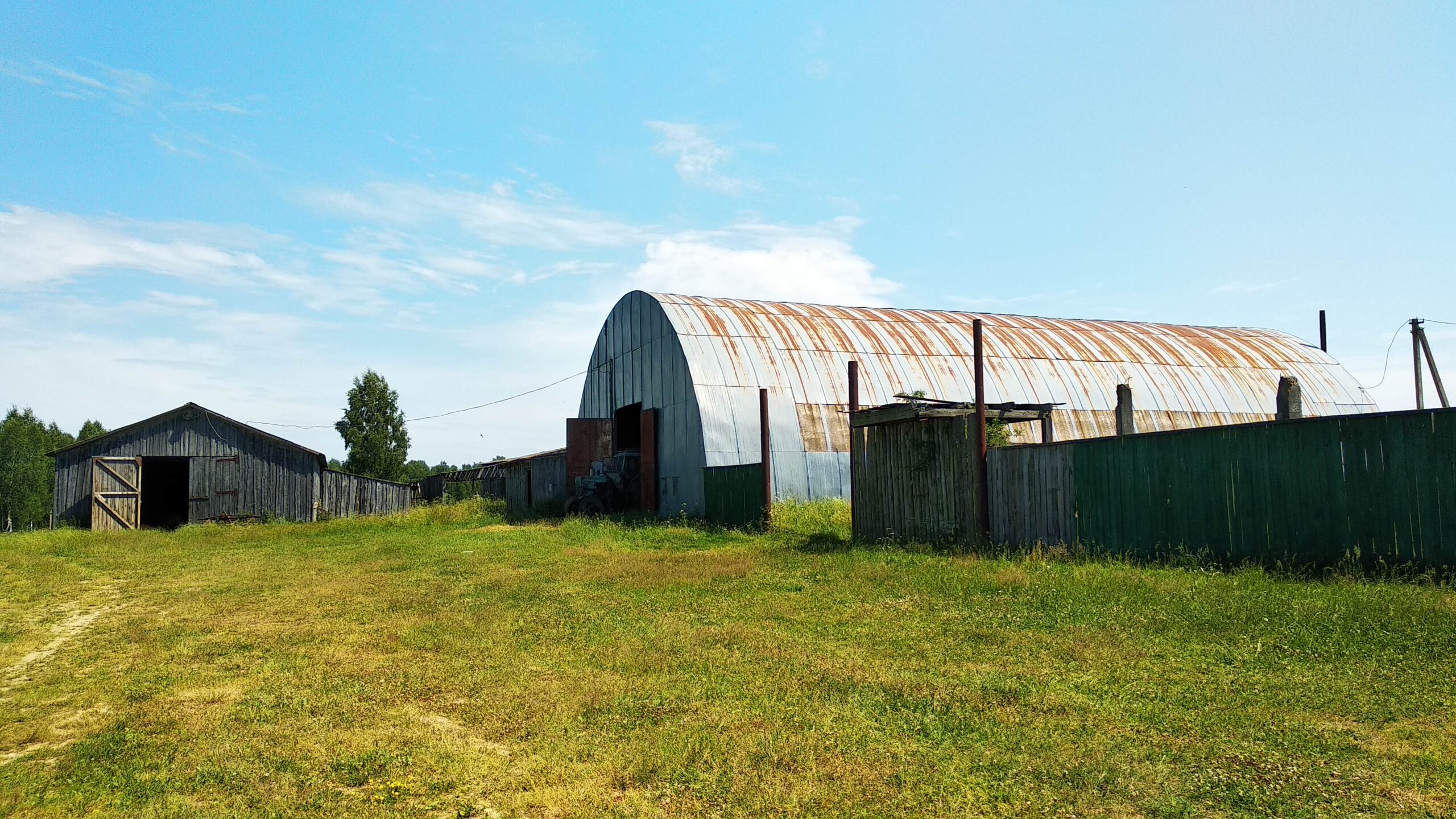 A house is for sale. A hangar, a plot of land for farming.