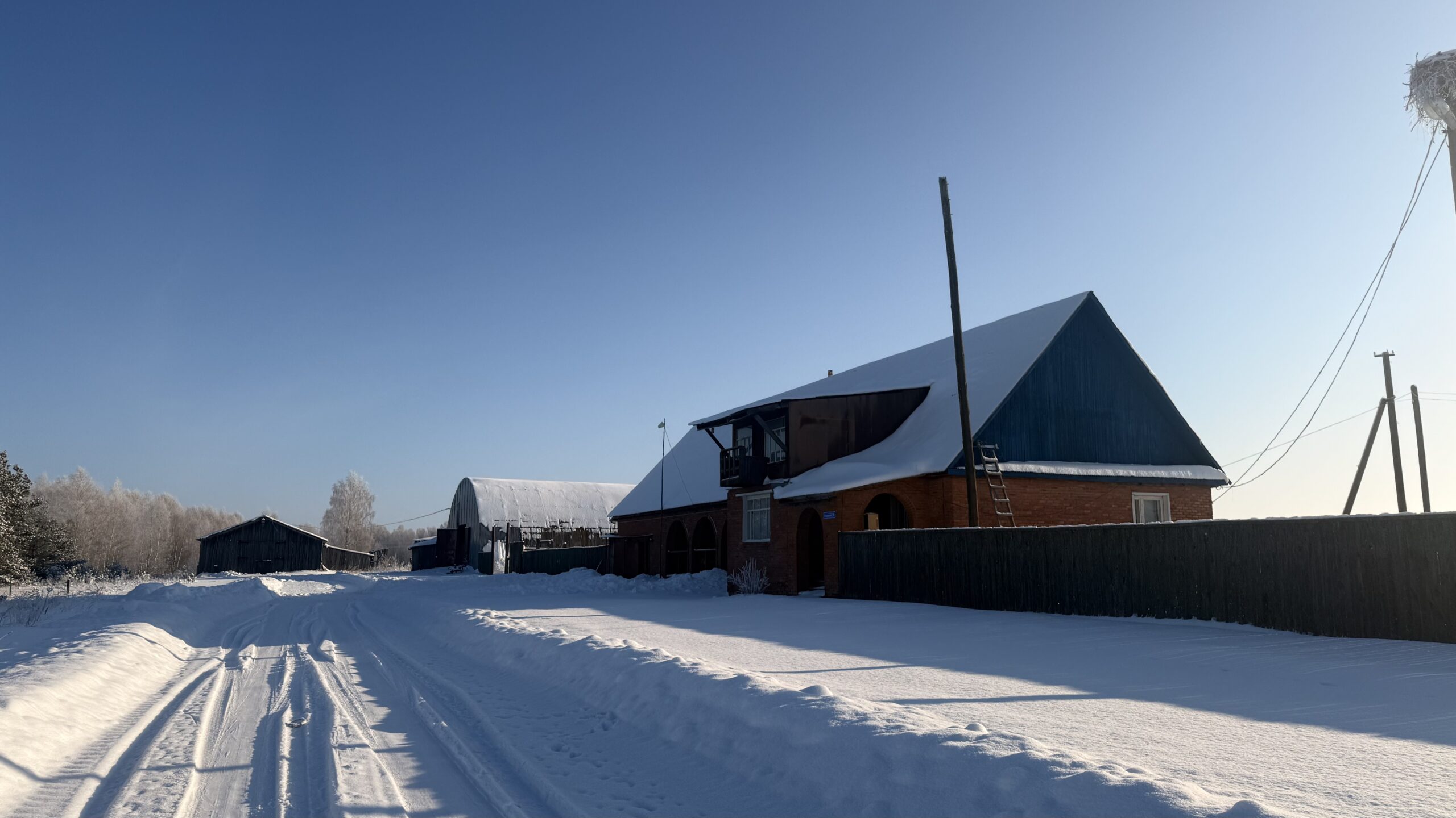 A house is for sale. A hangar, a plot of land for farming.