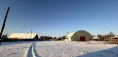 A house is for sale. A hangar, a plot of land for farming.