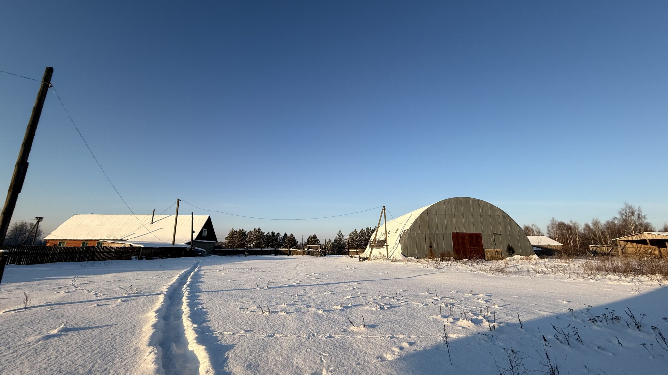 A house is for sale. A hangar, a plot of land for farming.